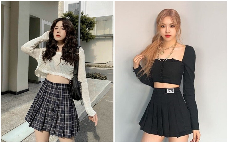 Cô gái mặc áo croptop ôm sát màu đen cùng chân váy xếp ly dài màu be, khoe eo thon