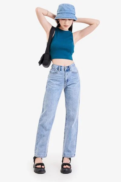 Cô gái trẻ trung trong áo croptop dệt kim và quần jean ống đứng cạp cao, phong cách công sở năng động và cá tính