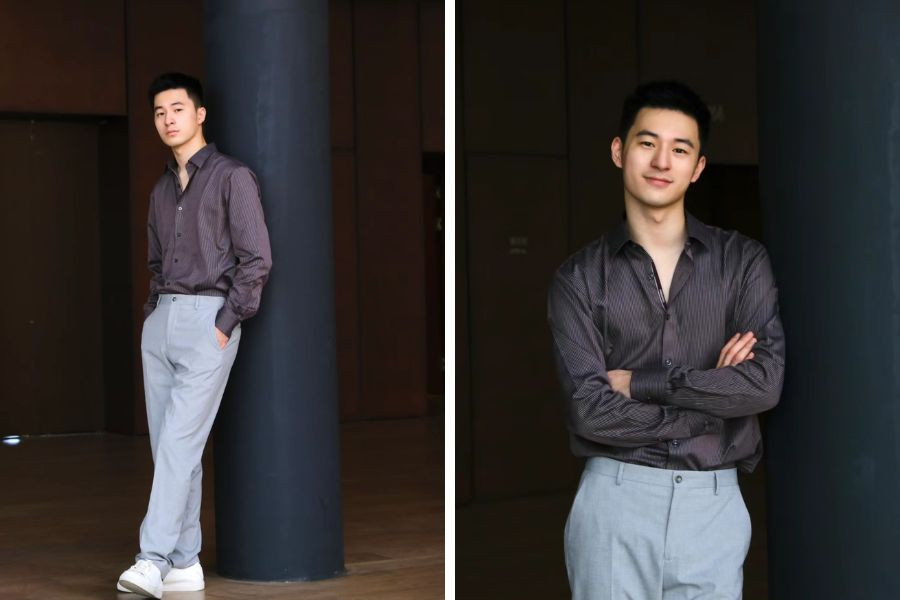 Chàng trai phong độ với áo sơ mi màu xanh tím than bóng nhẹ, kết hợp quần tây xanh nhạt và giày thể thao trắng.