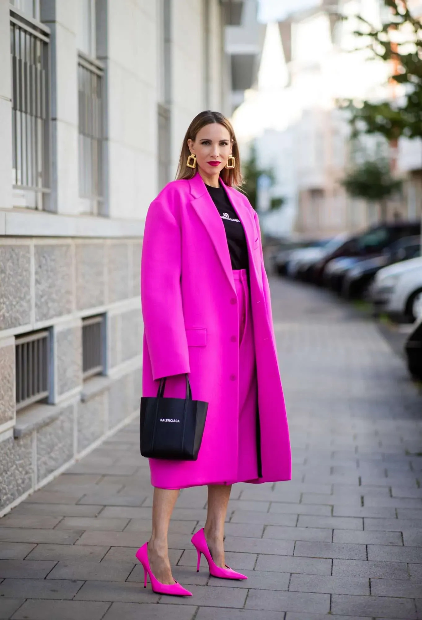 Outfit quần hồng đậm kết hợp áo hai dây màu đen mang lại sự gợi cảm và cuốn hút