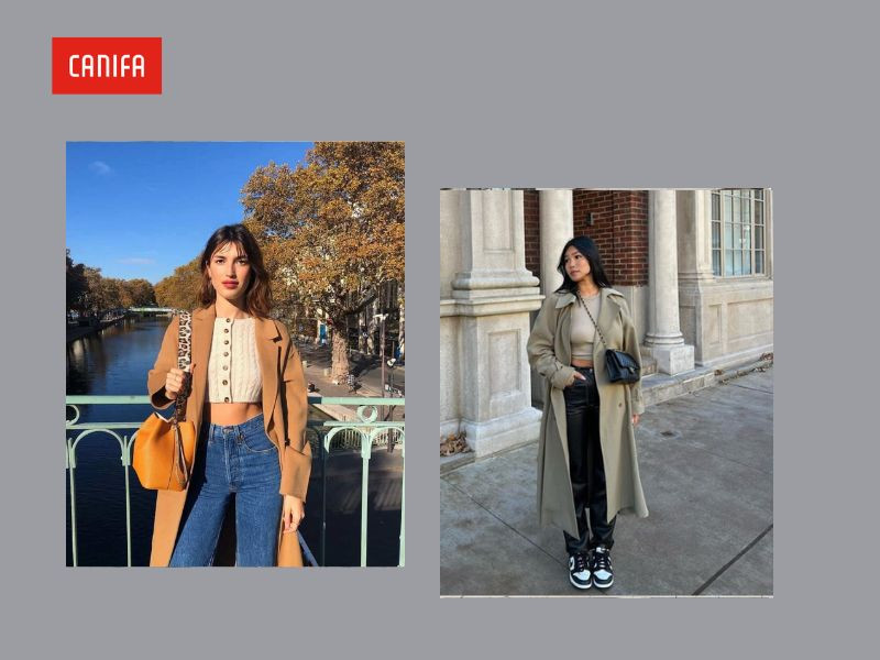 Phong cách cá tính với áo măng tô màu ghi đậm phối cùng áo crop top trắng và quần jeans cạp cao, khoe khéo vòng eo thon gọn, tạo sự năng động và hiện đại.