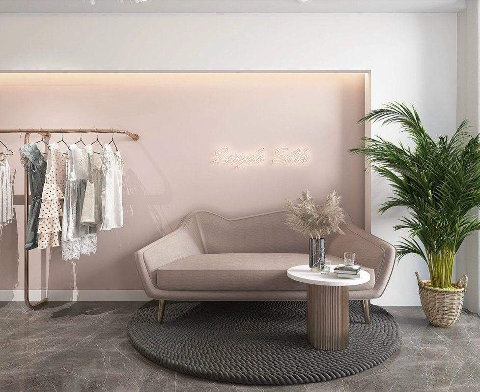 Phòng livestream quần áo sang trọng với gam màu hồng pastel, kết hợp thảm cói và cây xanh, tạo không gian cuốn hút, thu hút mọi ánh nhìn