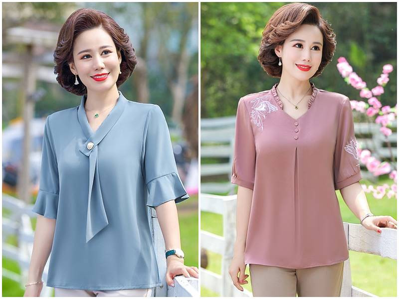 Quý cô U60 thanh lịch với áo kiểu màu trắng họa tiết đen và quần tây ống rộng, toát lên vẻ đẹp sang trọng, quý phái